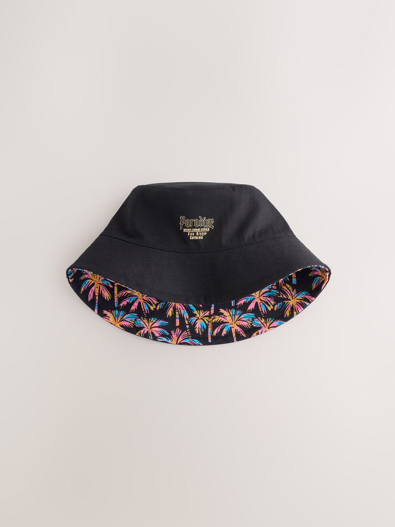Black reversible bucket hat with palm tree print, British brand