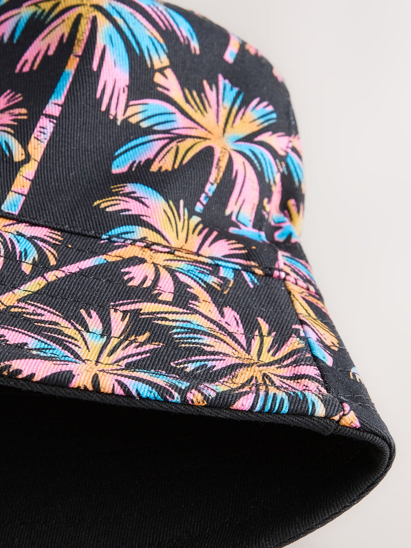Black reversible bucket hat with palm tree print, British brand