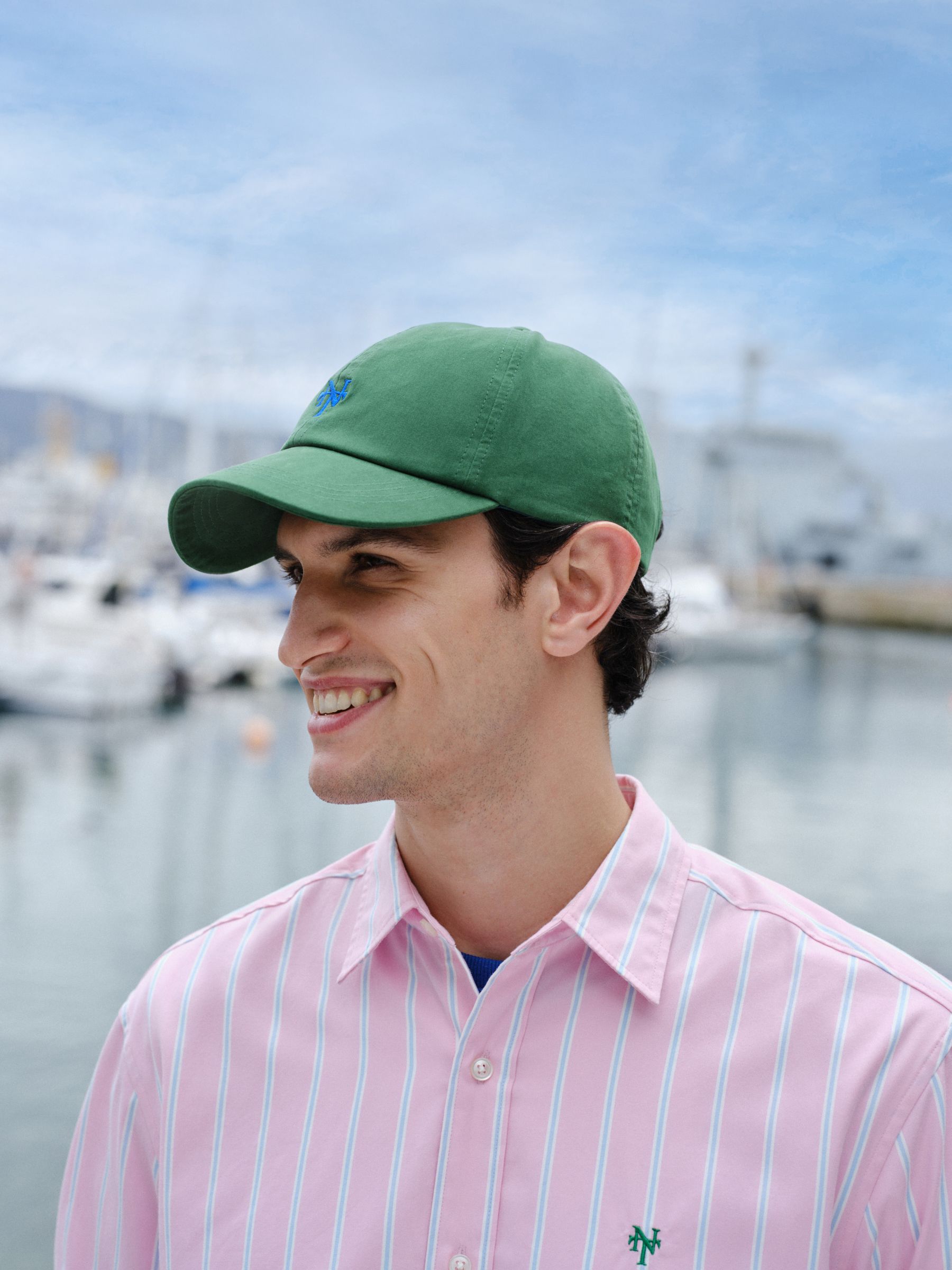 Green cap with red embroidery, imported from the UK