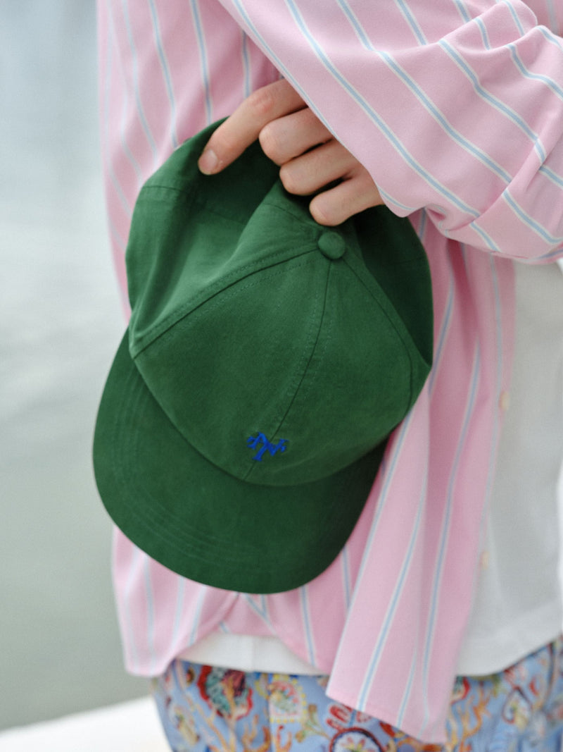 Green cap with red embroidery, imported from the UK