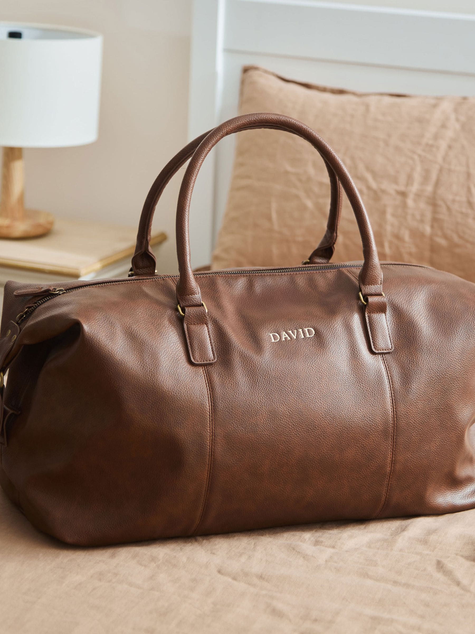 Personalised tan faux leather weekend bag, imported from the UK