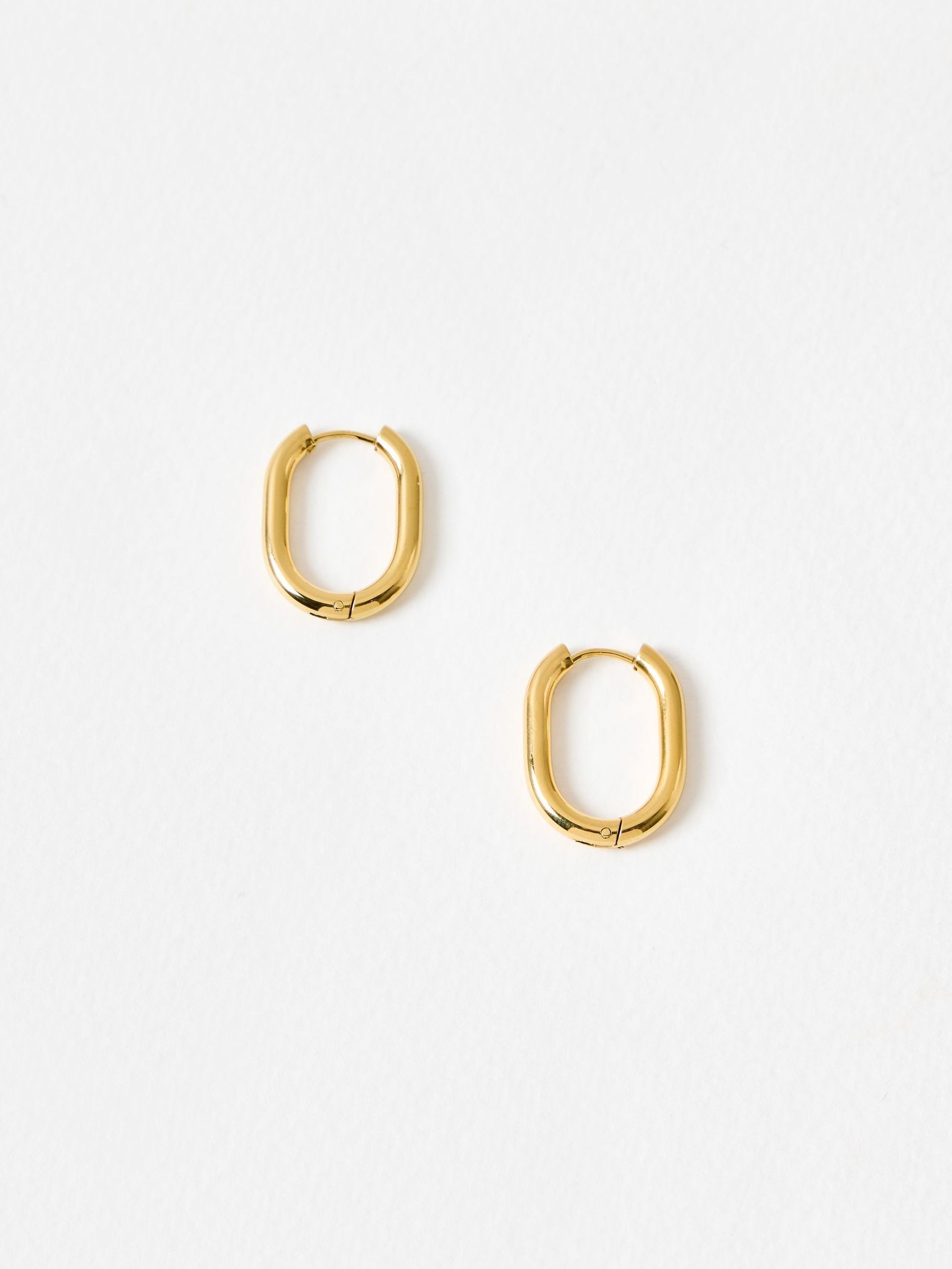 Oliver Bonas gold tone oval hoop earrings, imported from the UK