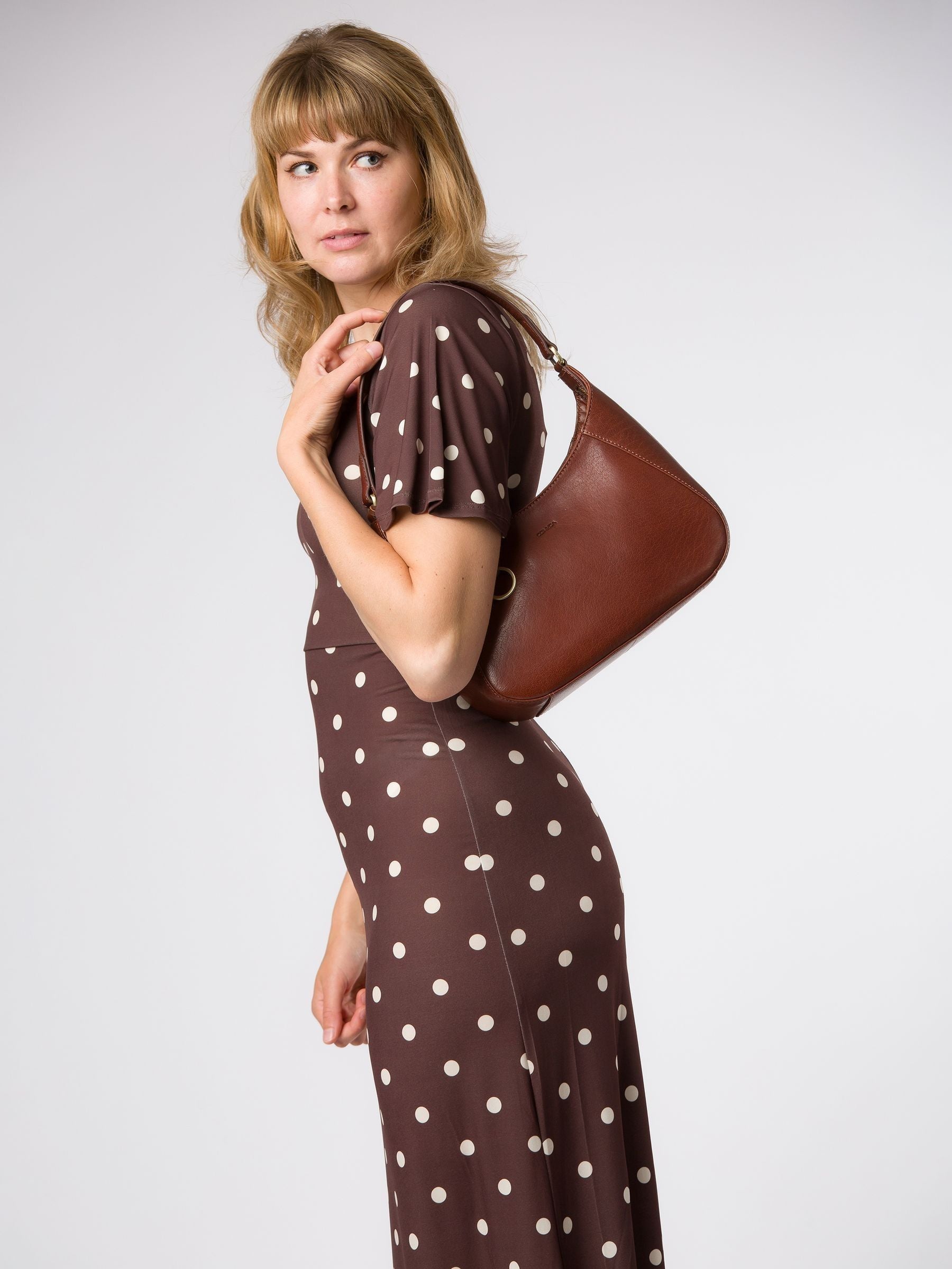 Conkca brown Vivienne leather grab bag with brass fittings, imported from the UK