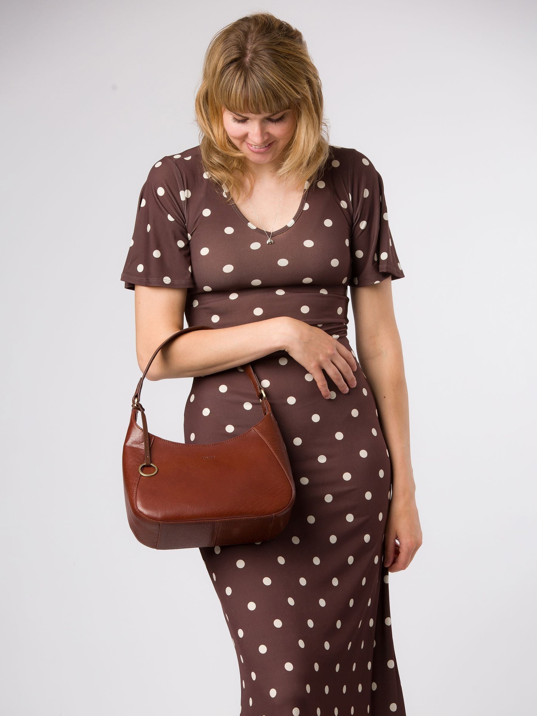 Conkca brown Vivienne leather grab bag with brass fittings, imported from the UK