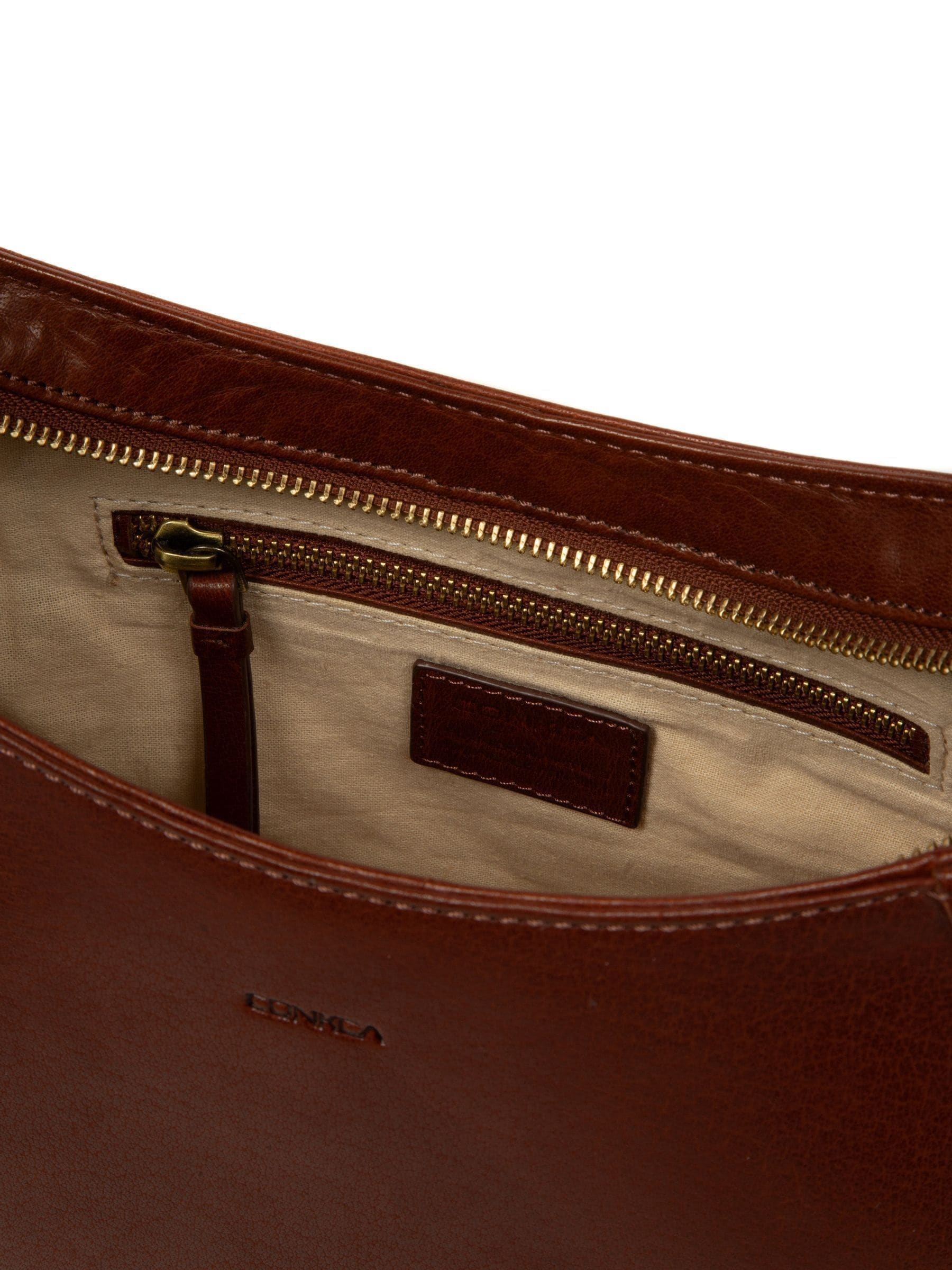 Conkca brown Vivienne leather grab bag with brass fittings, imported from the UK