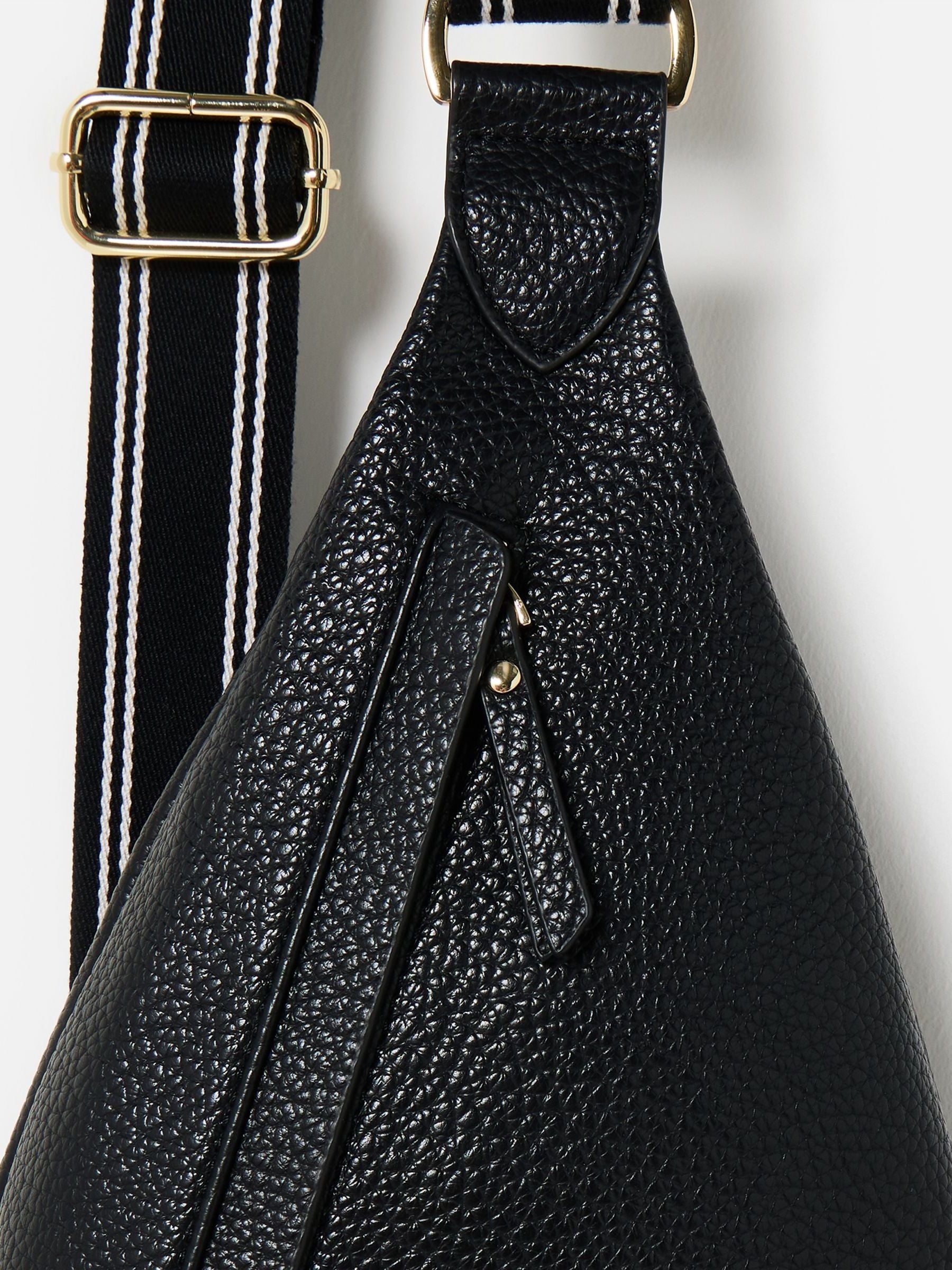 Oliver Bonas black belt bag with gold hardware, imported from the UK
