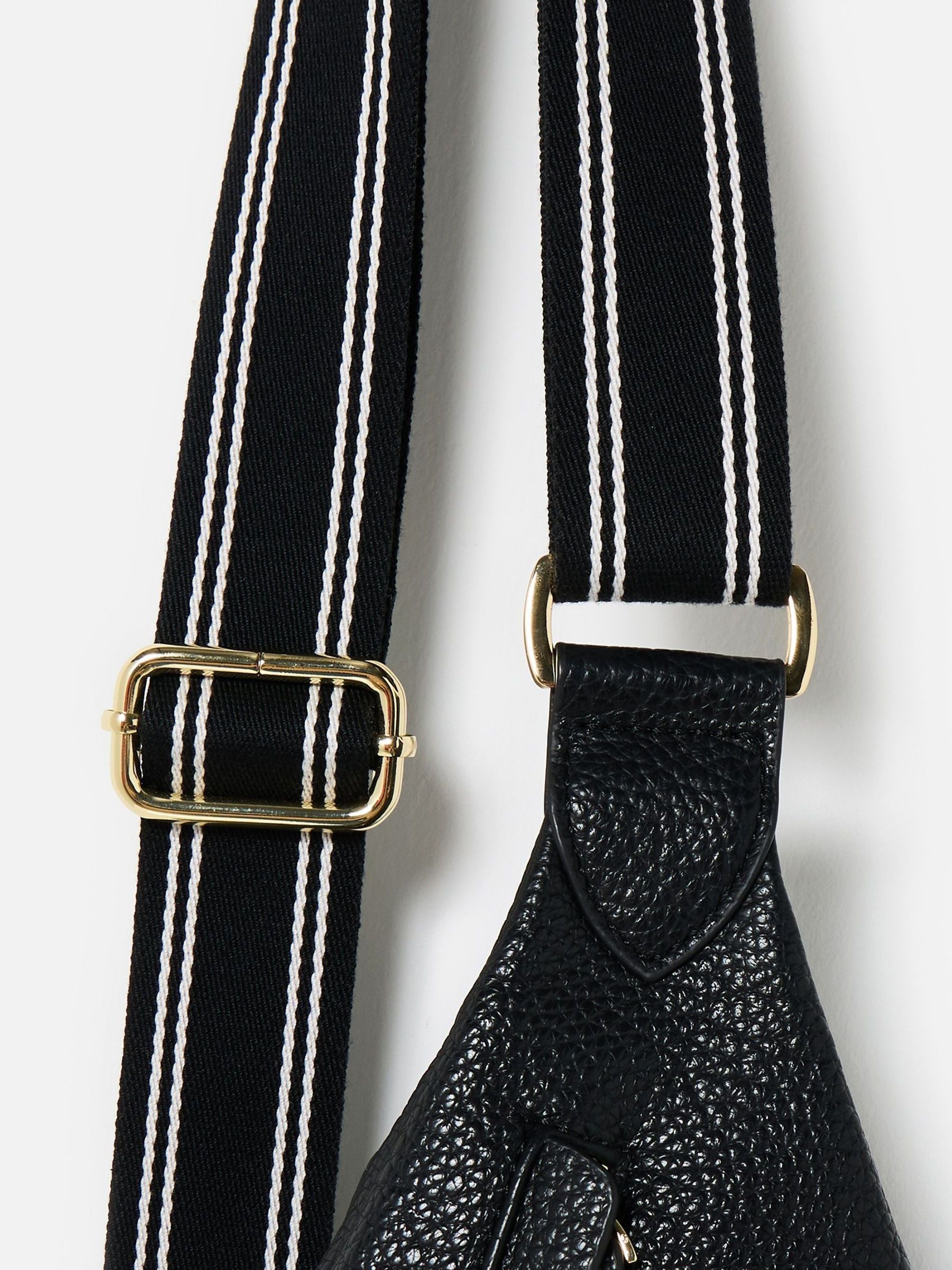 Oliver Bonas black belt bag with gold hardware, imported from the UK