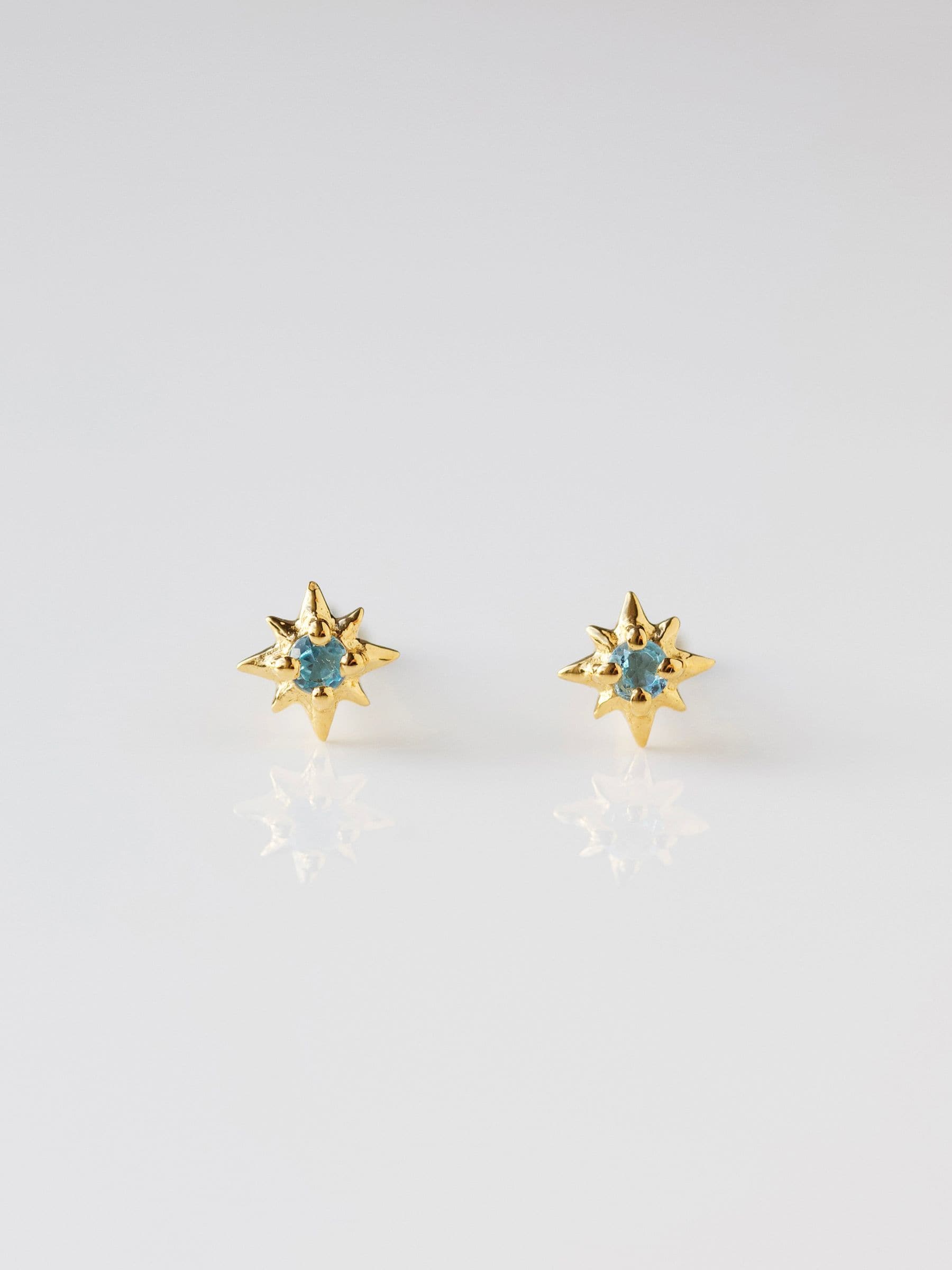 Carrie Elizabeth Gold Tone Dainty Blue Topaz Star Stud Earrings