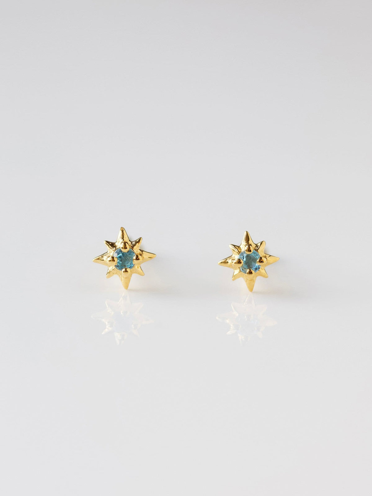 Carrie Elizabeth Gold Tone Dainty Blue Topaz Star Stud Earrings