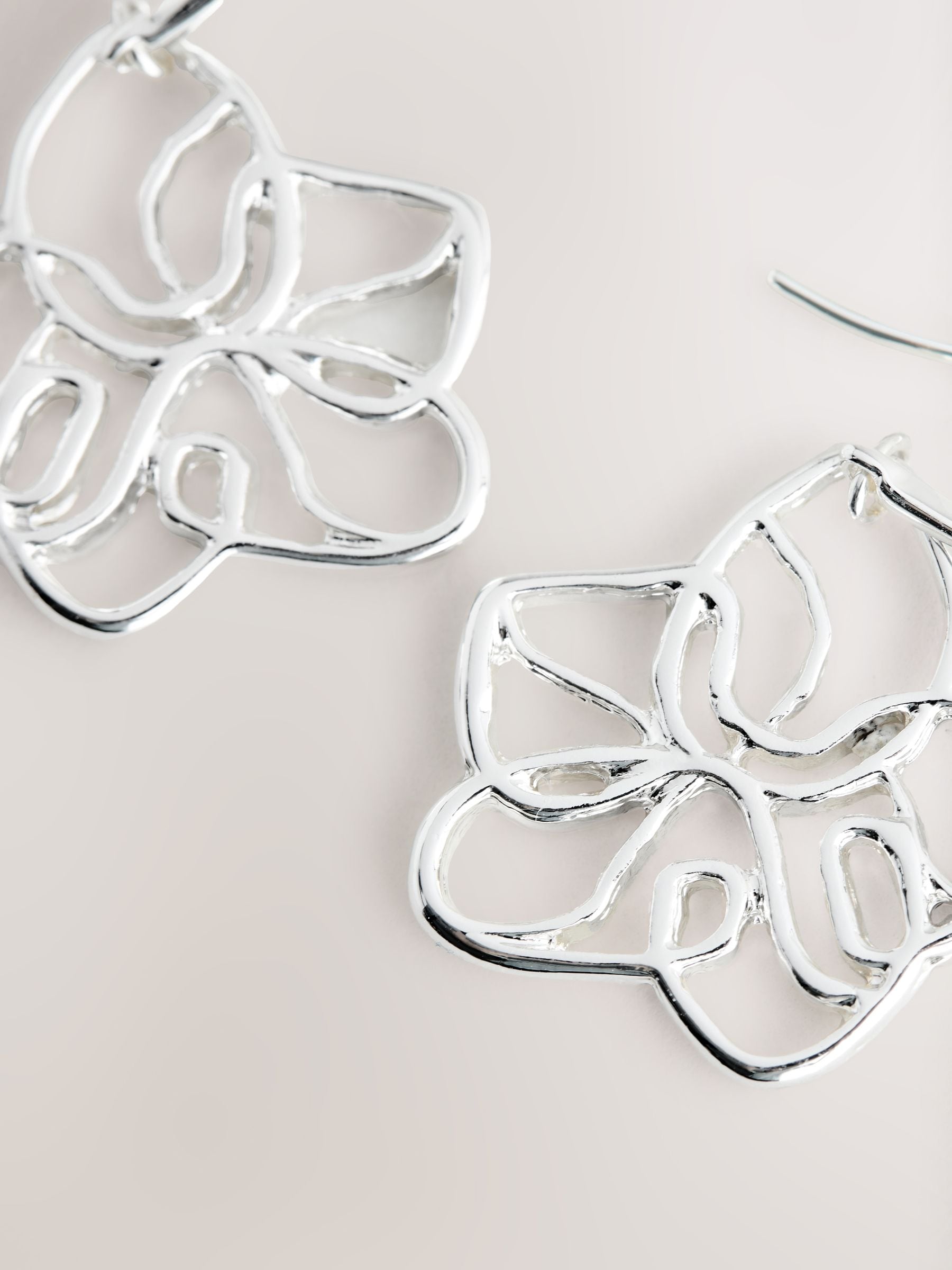 Silver tone flower drop earrings with fish-hook fastening, UK version