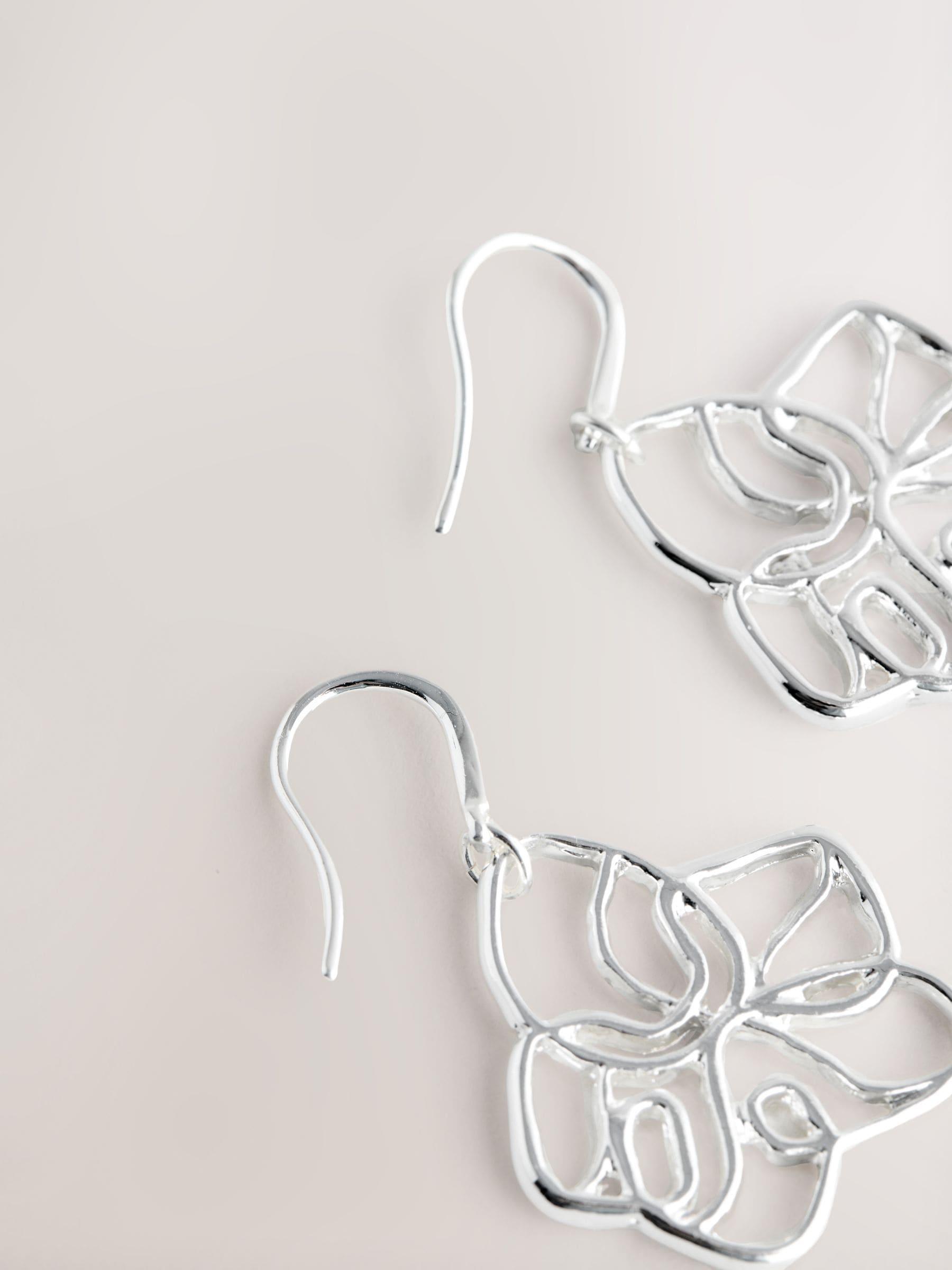 Silver tone flower drop earrings with fish-hook fastening, UK version
