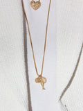 Tabitha Simmons gold tone layered charm necklace, imported from the UK
