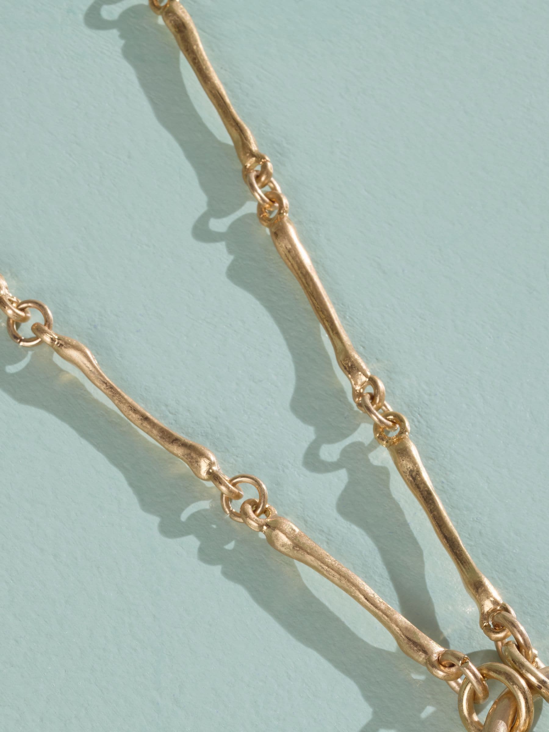 Tabitha Simmons gold tone layered charm necklace, imported from the UK