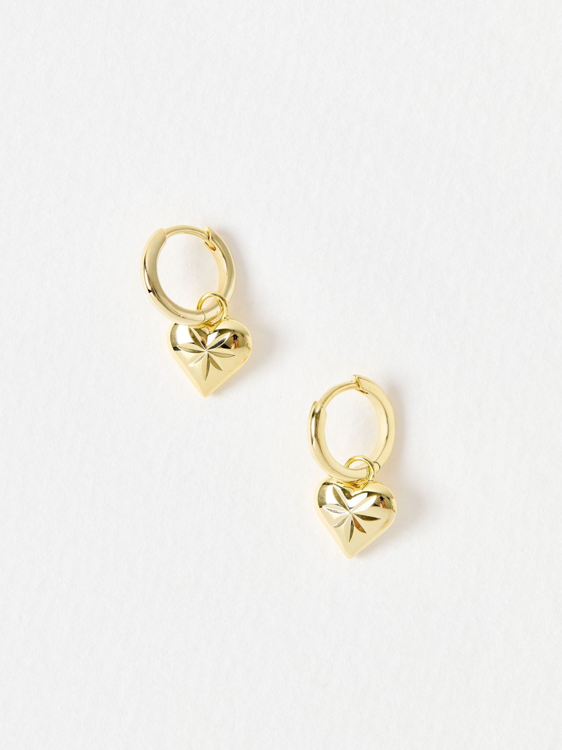 Oliver Bonas Cora engraved heart charm hoop drop earrings, UK version