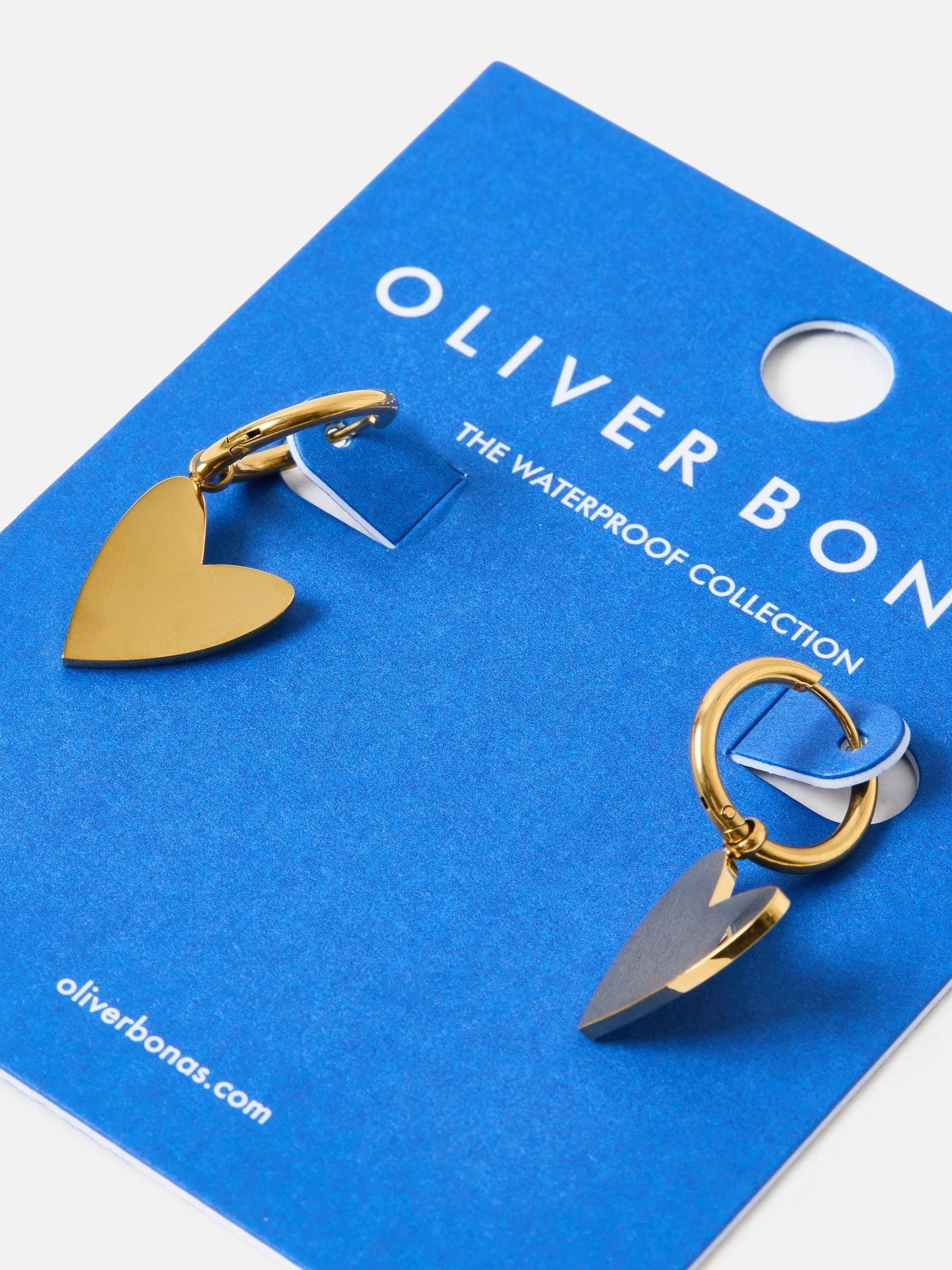 Oliver Bonas gold tone heart huggie earrings, imported from the UK