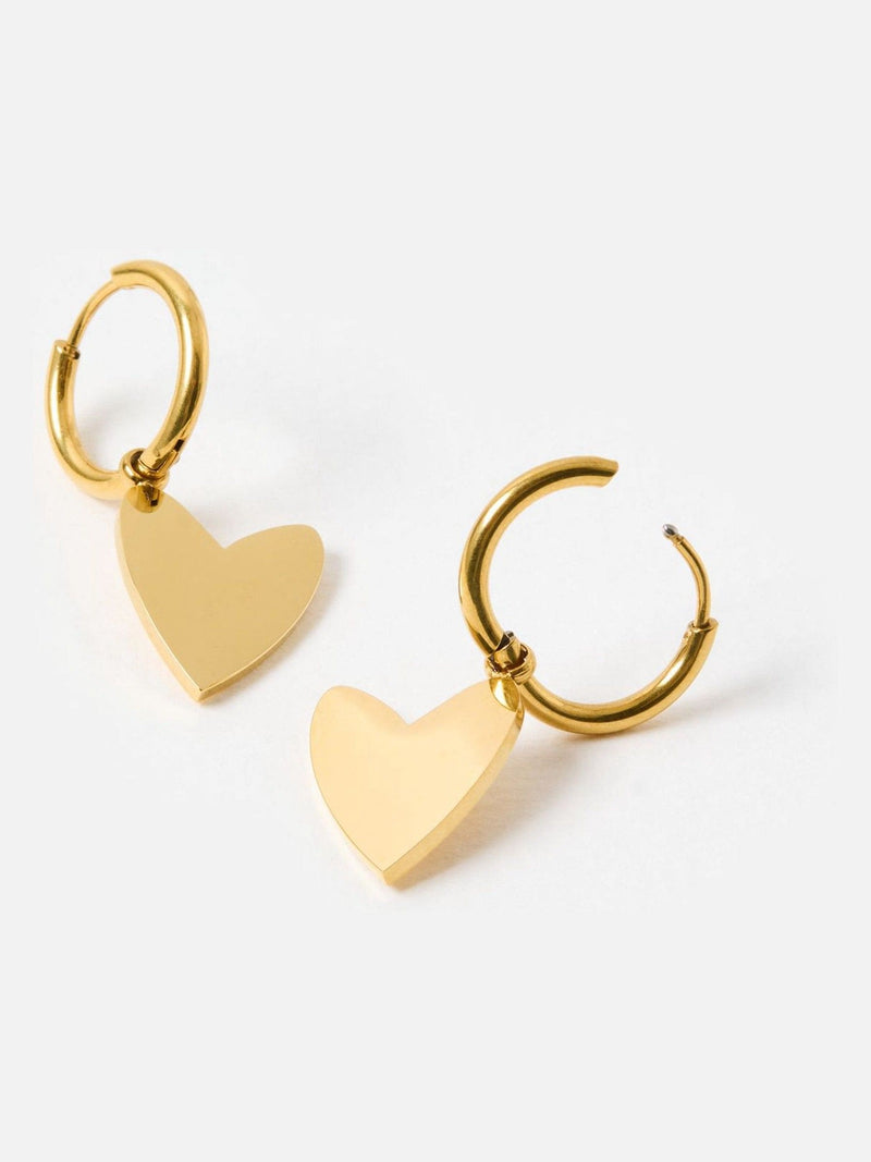 Oliver Bonas gold tone heart huggie earrings, imported from the UK