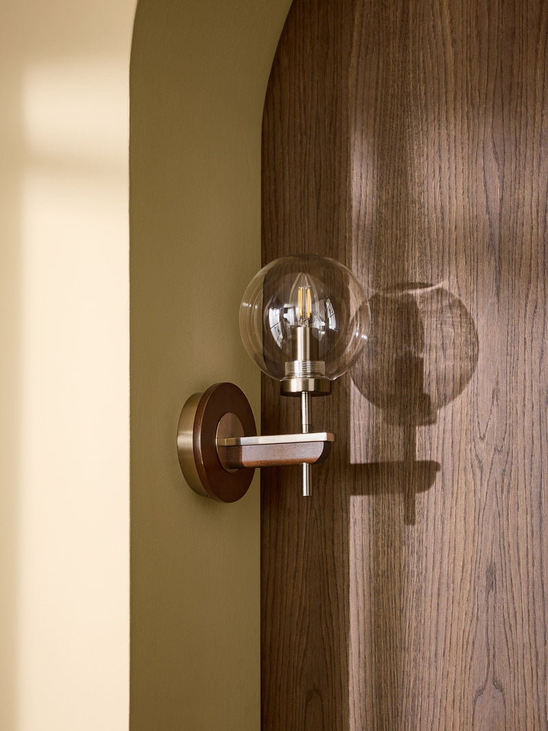 Archer wall light in dark natural wood with brass accents, British product