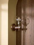 Archer wall light in dark natural wood with brass accents, British product