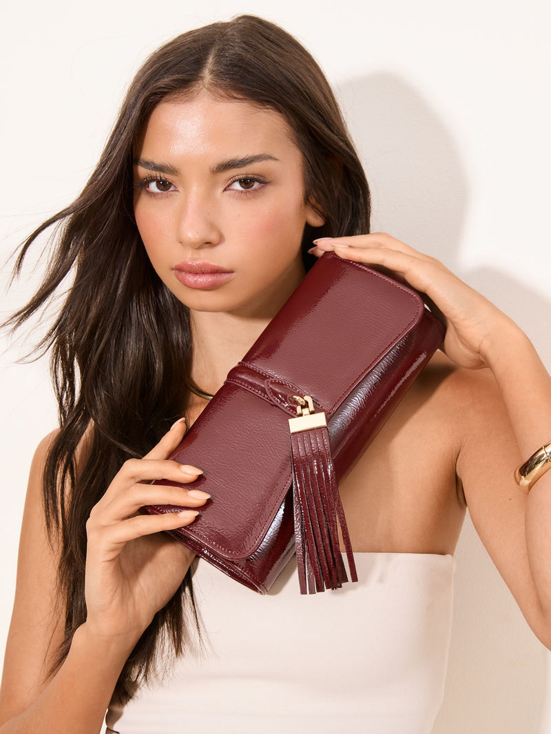 Lipsy burgundy red tassel trim clutch bag, UK version