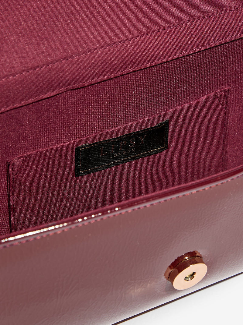 Lipsy burgundy red tassel trim clutch bag, UK version