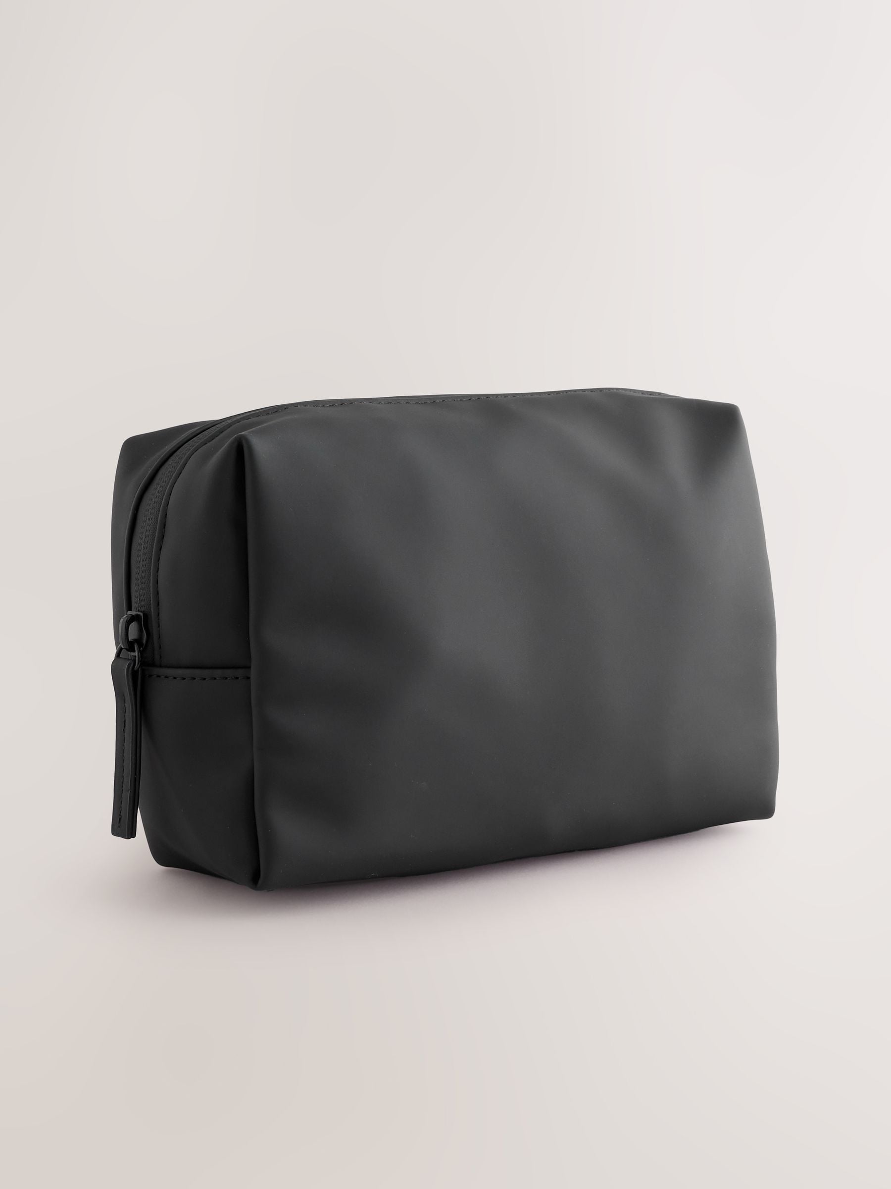 Black rubberised washbag with water-resistant finish, UK version
