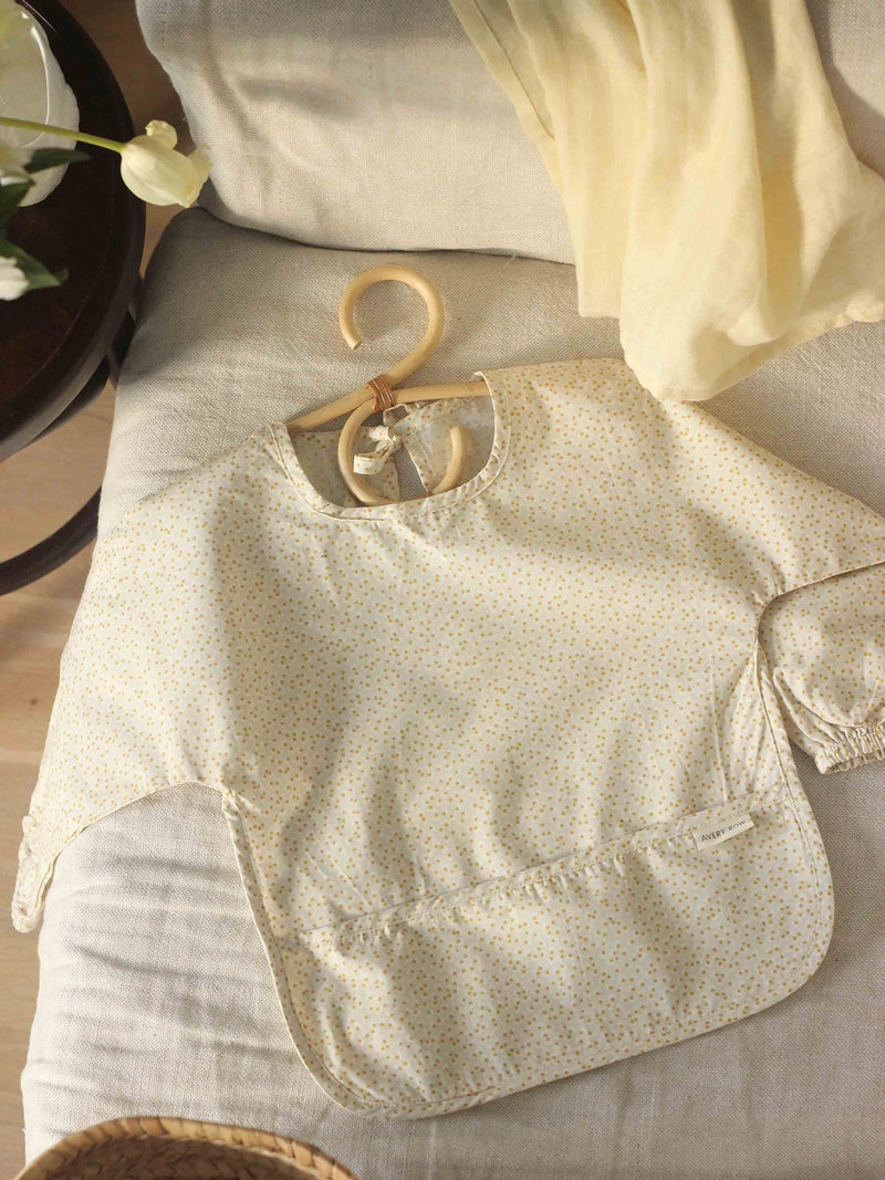 Avery Row sleeved bib in Daisy Meadow pattern (British brand)