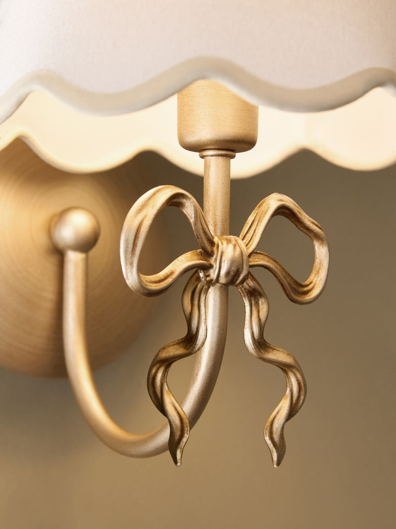Brass Bow rechargeable wall light with fabric shade, imported from the UK