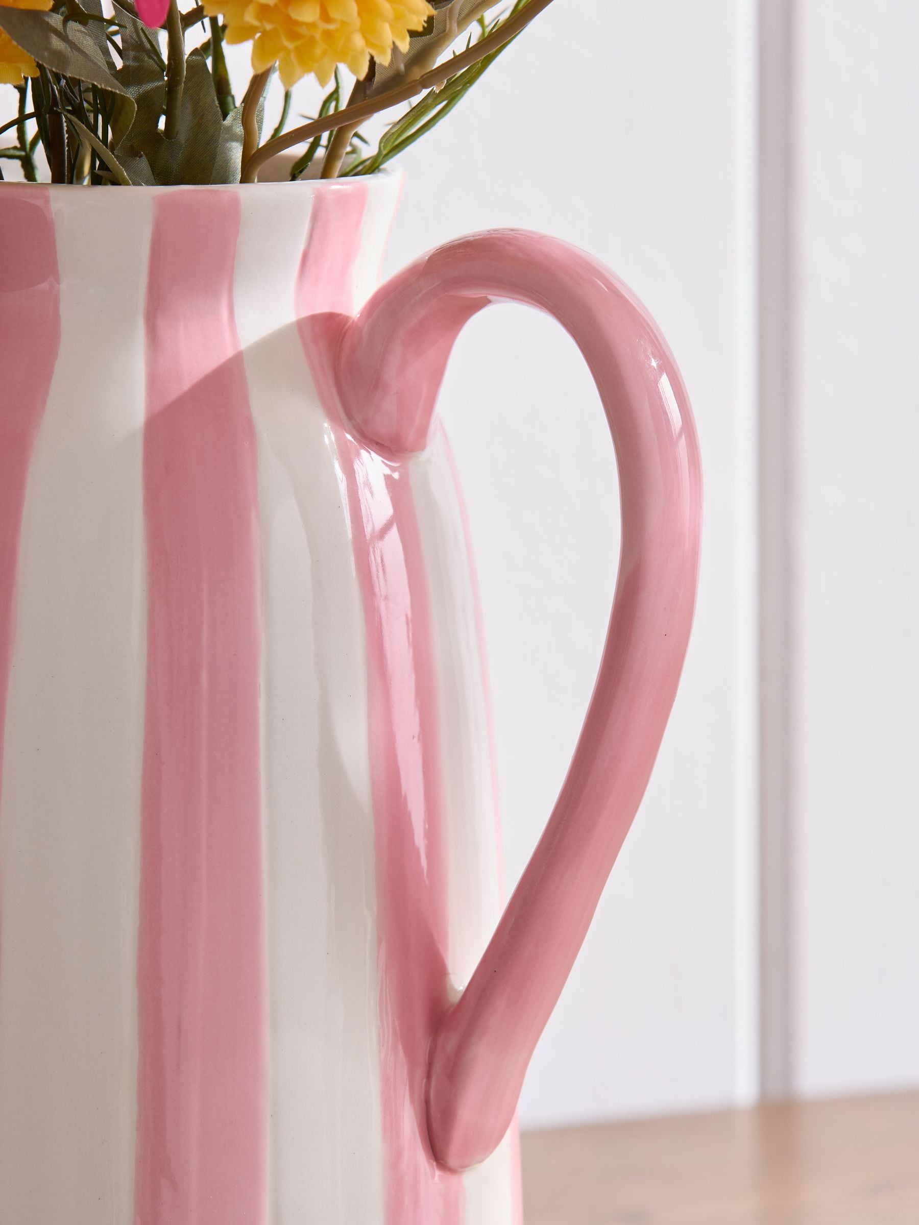 Lucy Tiffney pink artificial dahlia arrangement in striped jug vase, UK version