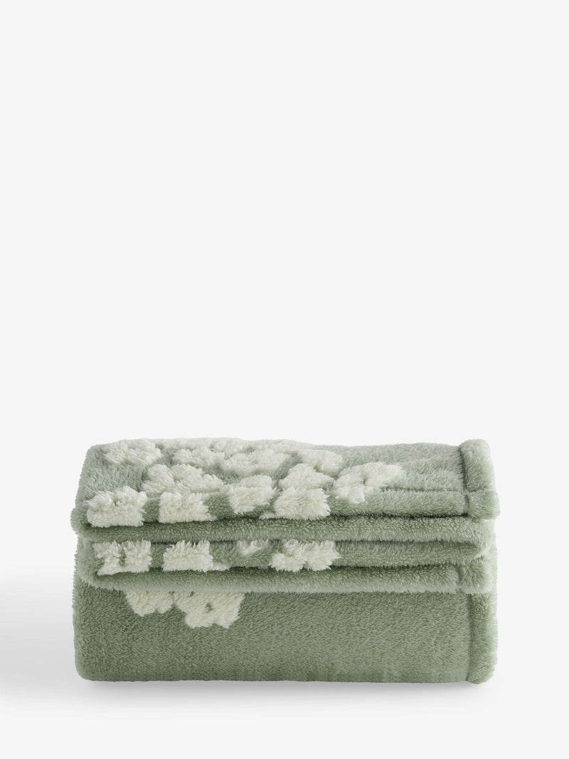 Sage green fleece throw with floral heart motifs, UK version