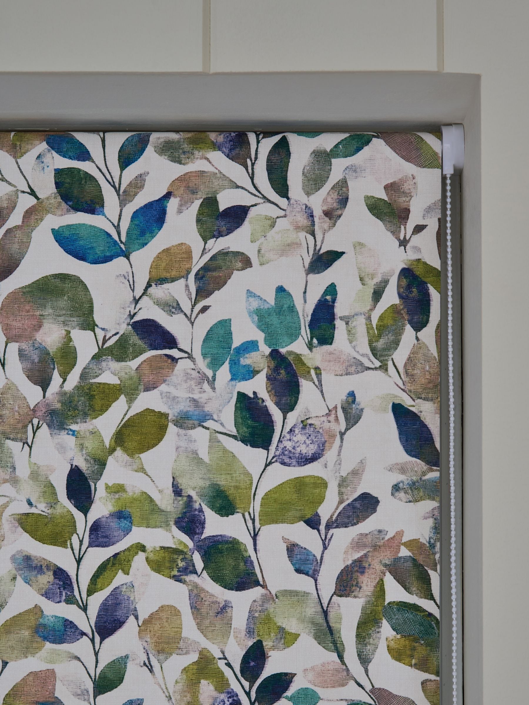 Multicoloured leaf print blackout roller blind, imported from the UK