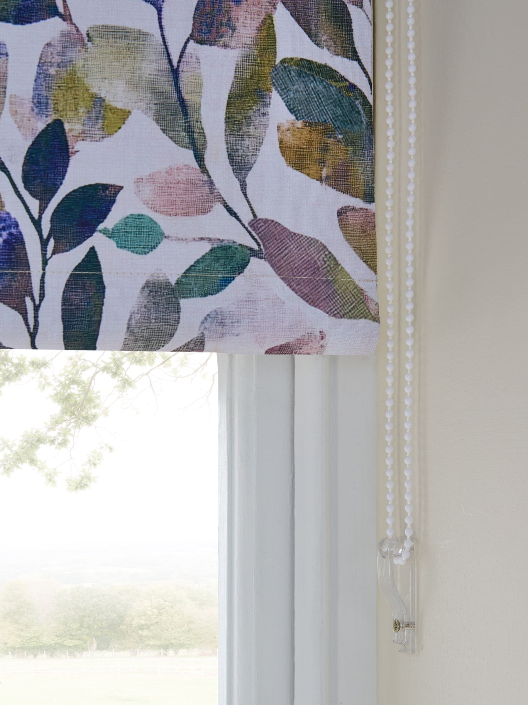 Multicoloured leaf print blackout roller blind, imported from the UK