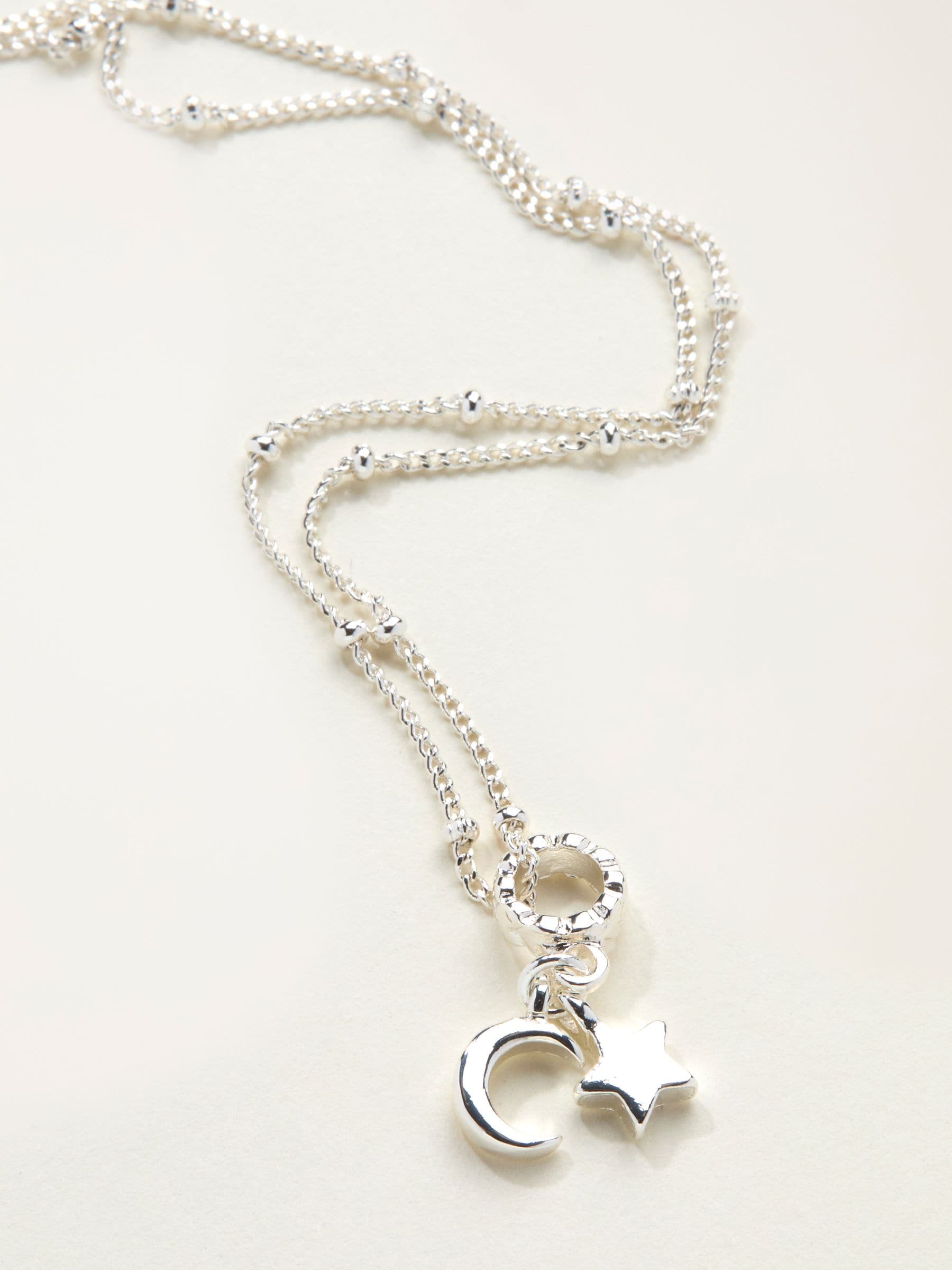 FatFace silver tone star and moon necklace, imported from the UK