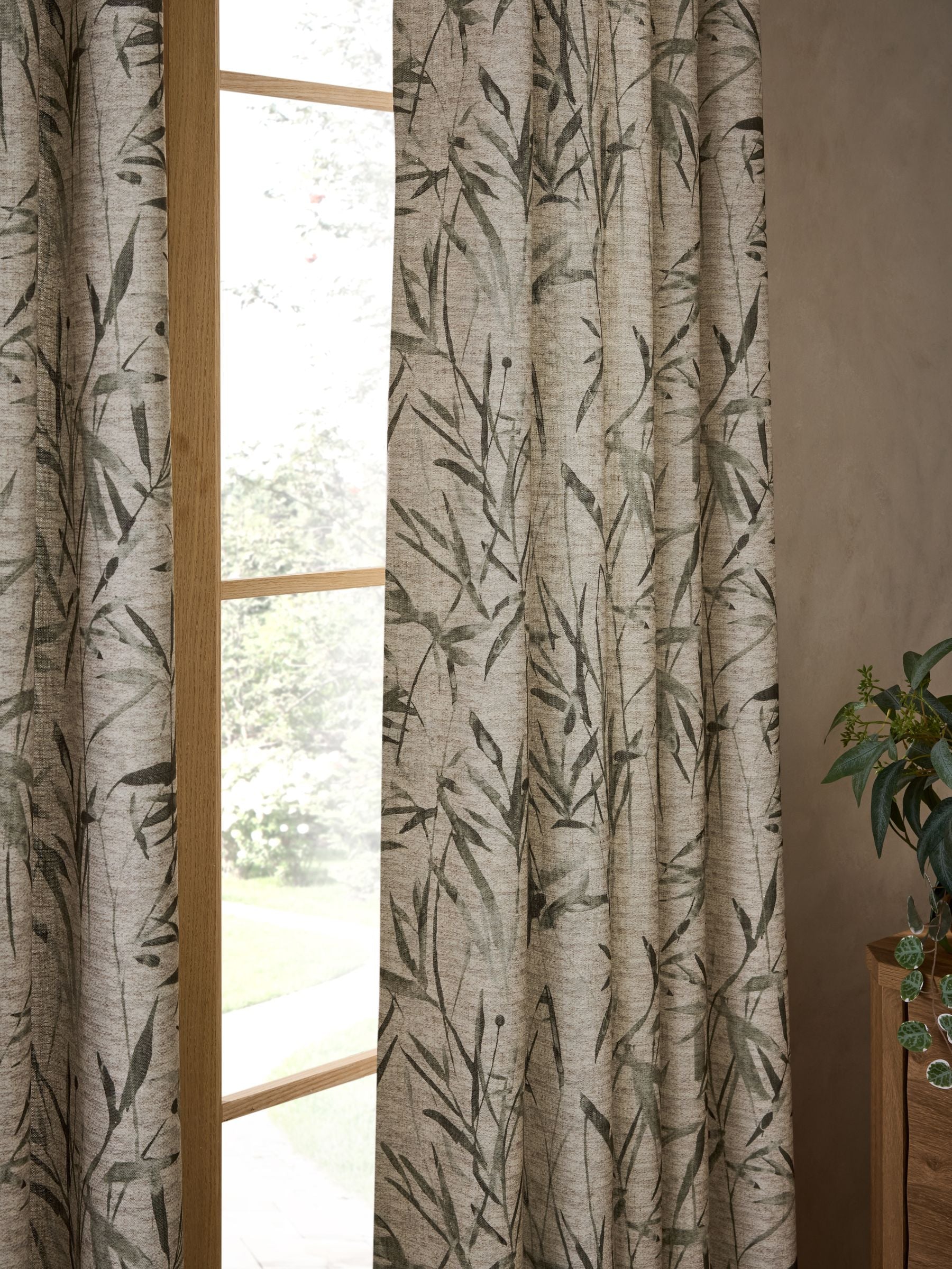 Curtains with blurred leaf print eyelet in olive green (British brand)