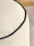 Black velvet pouffe with contrast piping, British brand