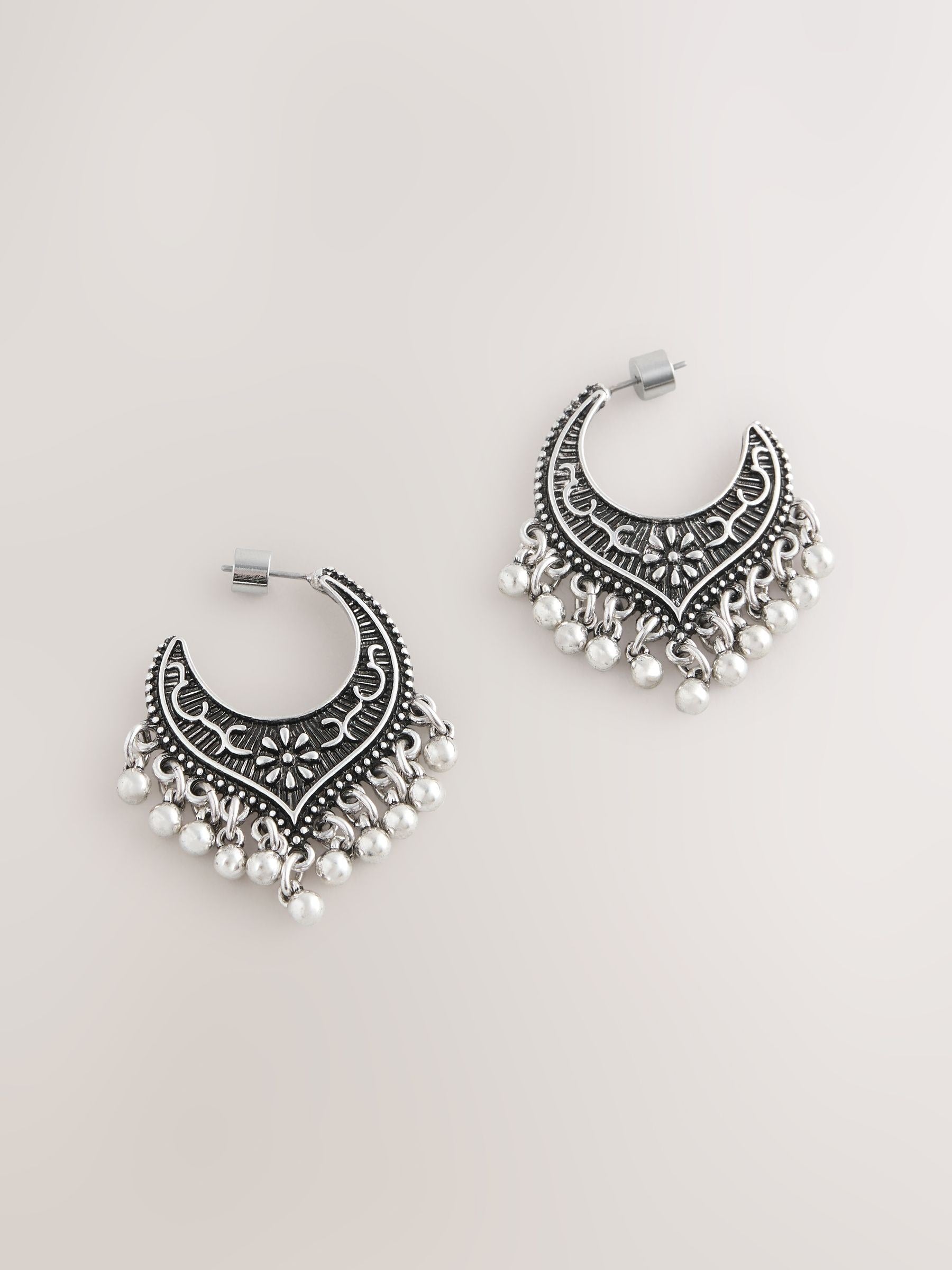 Burnished silver tone drop hoop earrings, imported from the UK