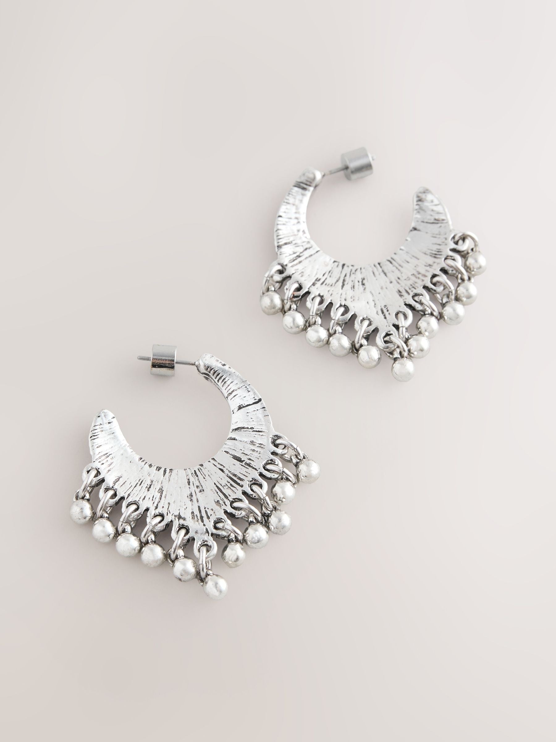 Burnished silver tone drop hoop earrings, imported from the UK