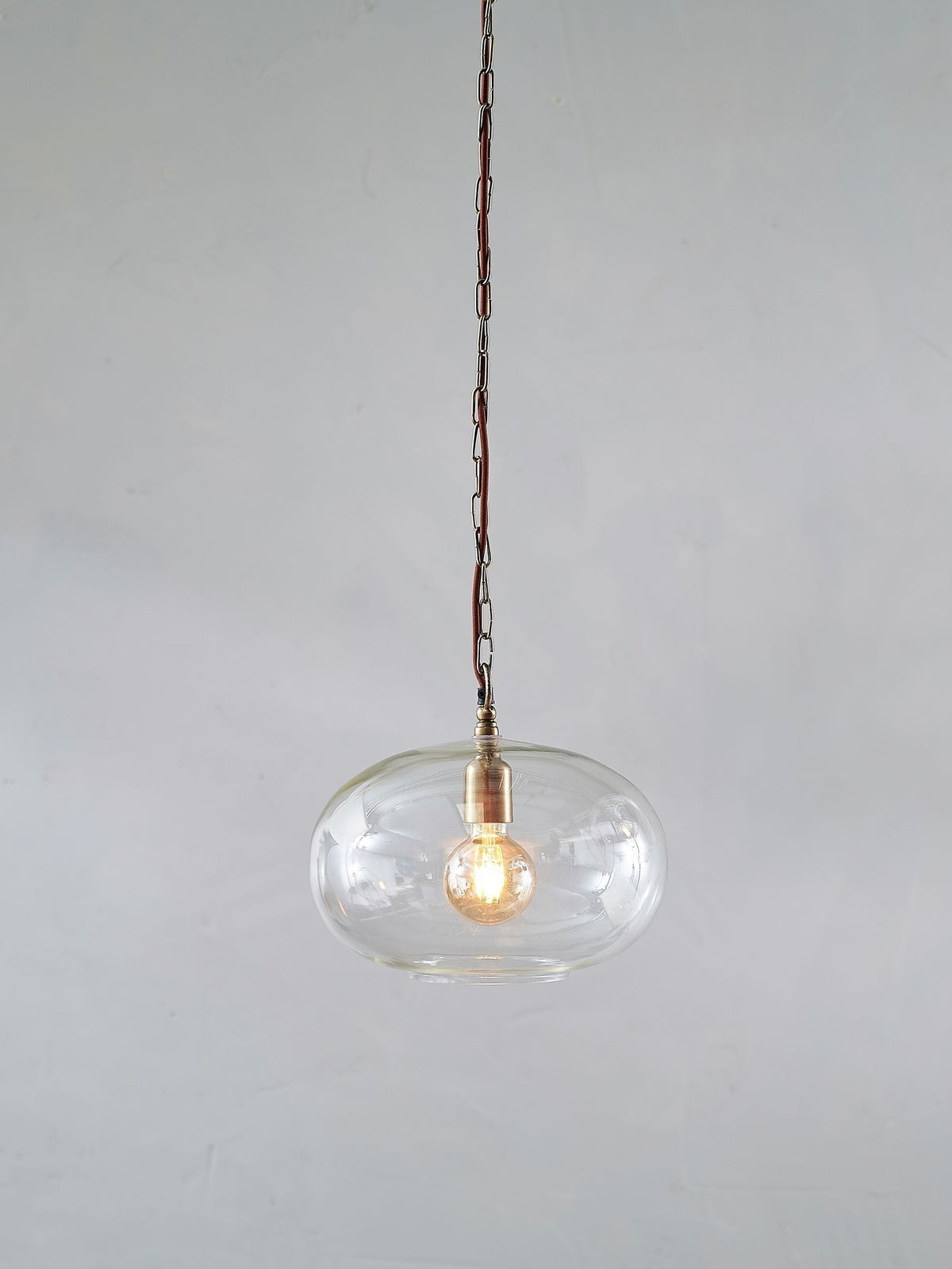 Nkuku clear glass pendant ceiling light with brass fittings - British product