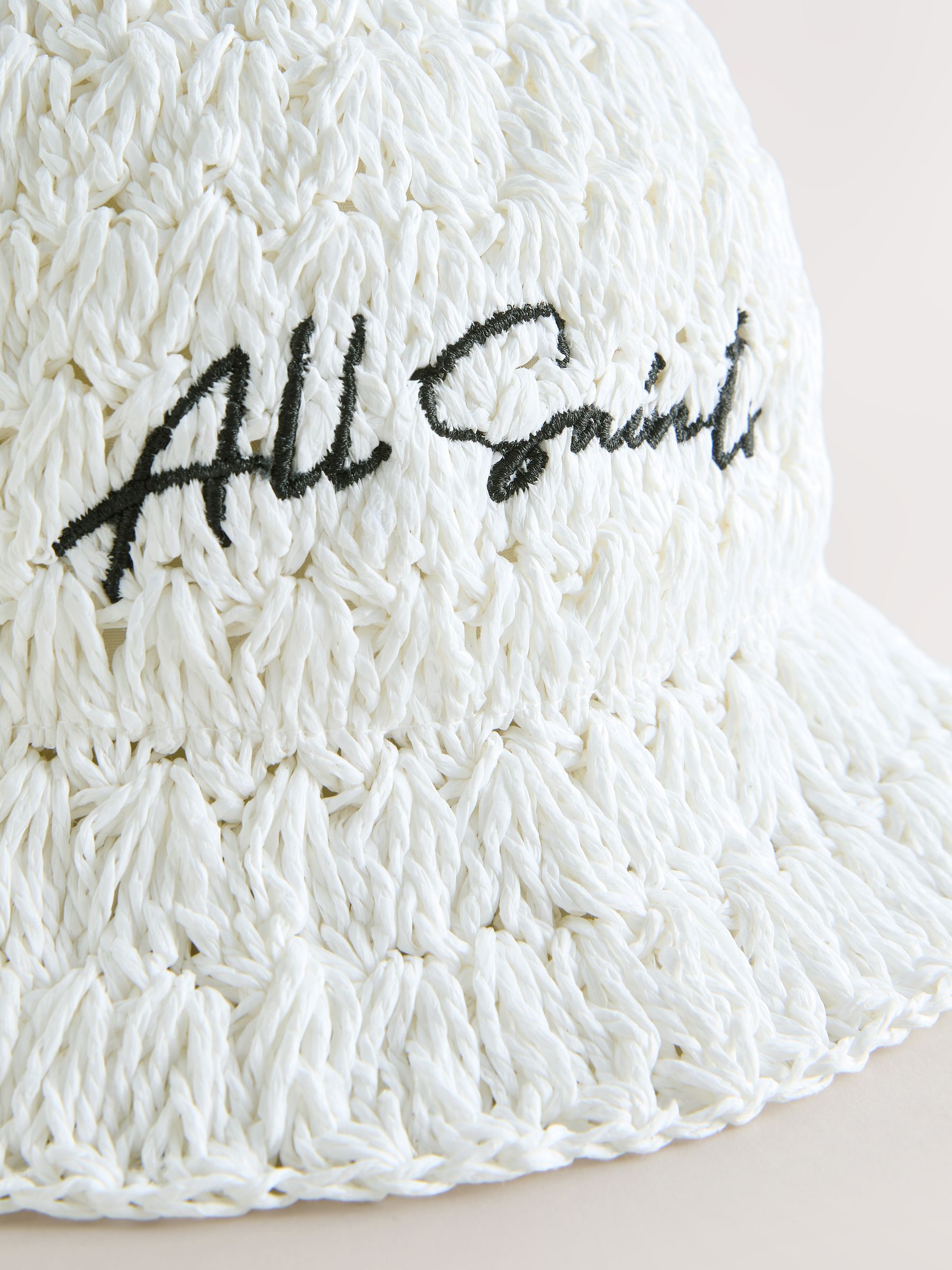 smALLSAINTS straw effect bucket hat with black logo (British brand)