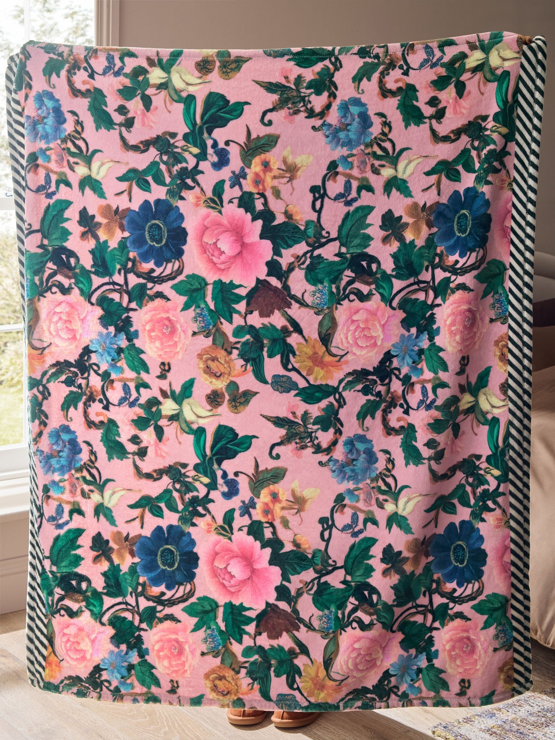 Pink floral fleece throw made from recycled polyester, imported from the UK