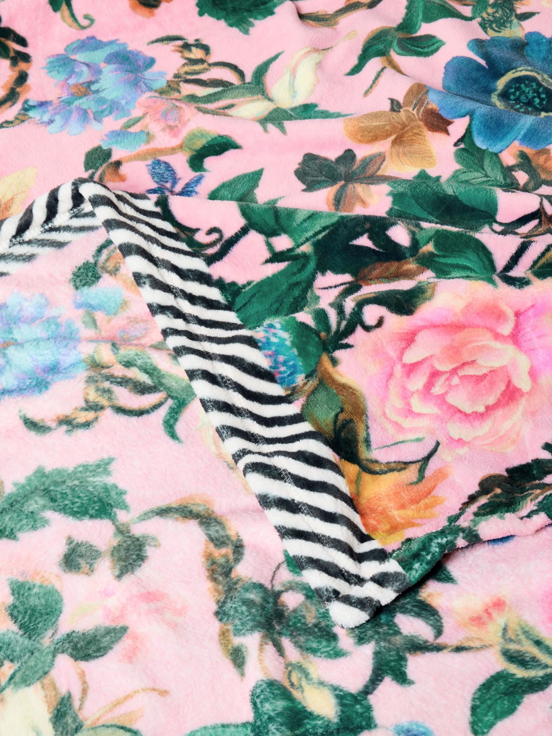 Pink floral fleece throw made from recycled polyester, imported from the UK