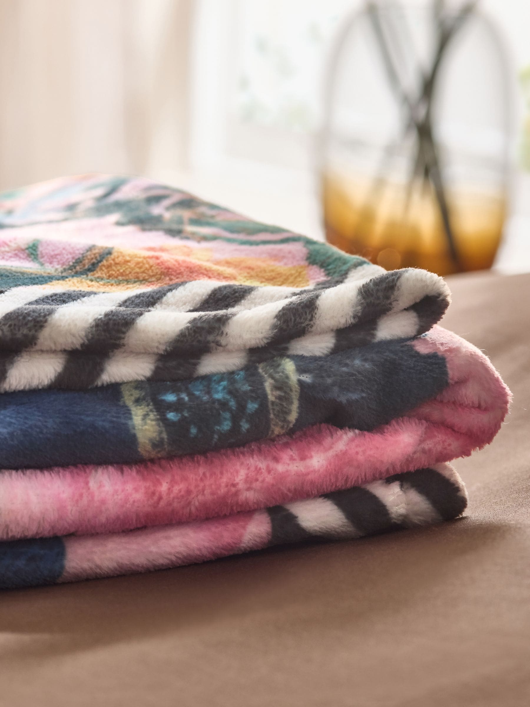 Pink floral fleece throw made from recycled polyester, imported from the UK