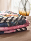 Pink floral fleece throw made from recycled polyester, imported from the UK