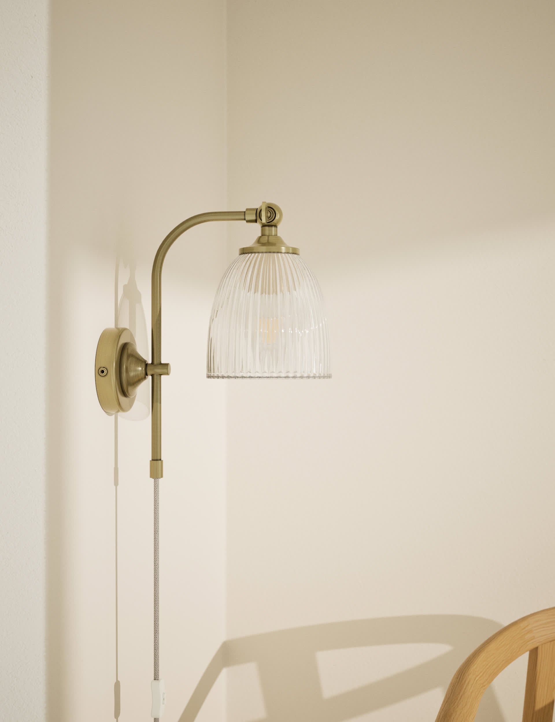 Ribbed plug in wall light with antique brass finish, imported from the UK