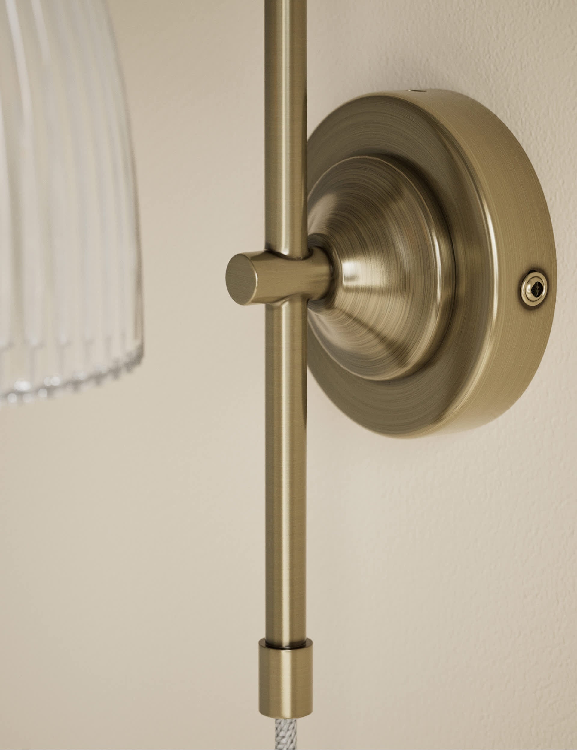 Ribbed plug in wall light with antique brass finish, imported from the UK