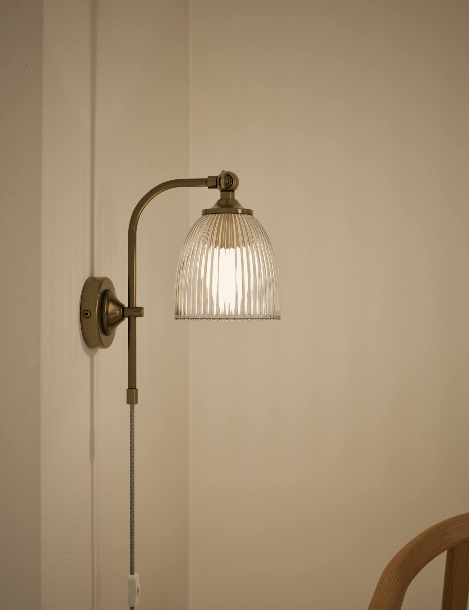 Ribbed plug in wall light with antique brass finish, imported from the UK