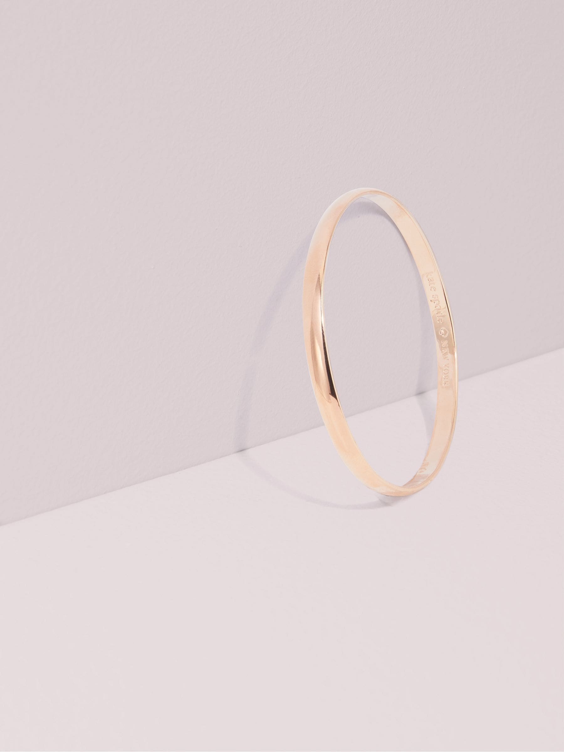 Kate Spade rose gold tone idiom bangle, UK version