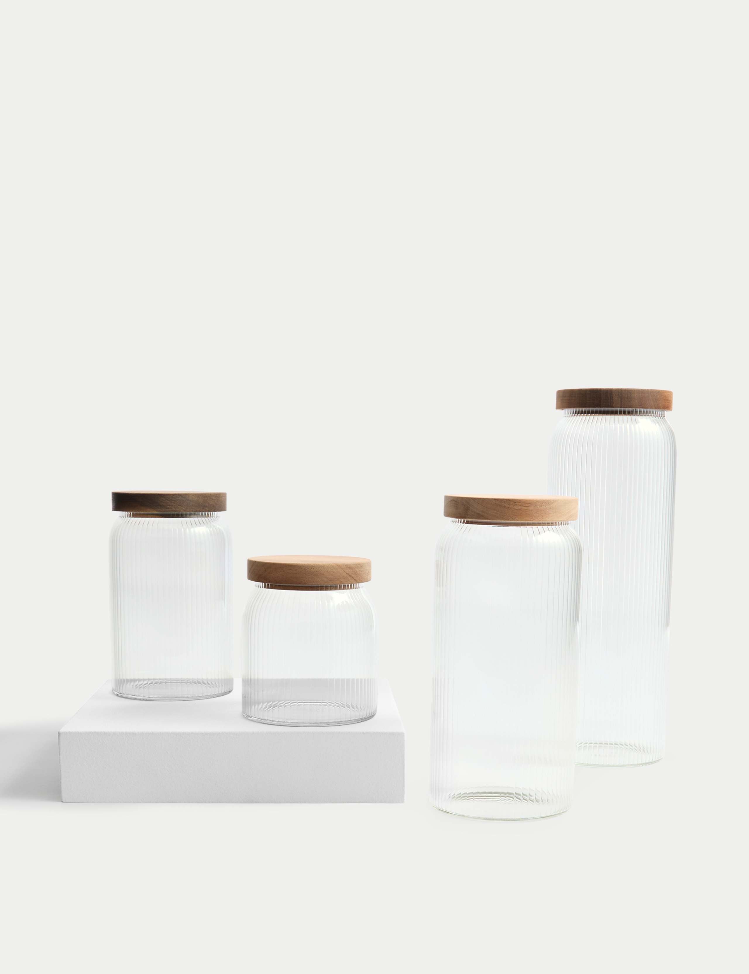 Medium ribbed glass storage jar with wooden lid, 16cm tall, imported from the UK