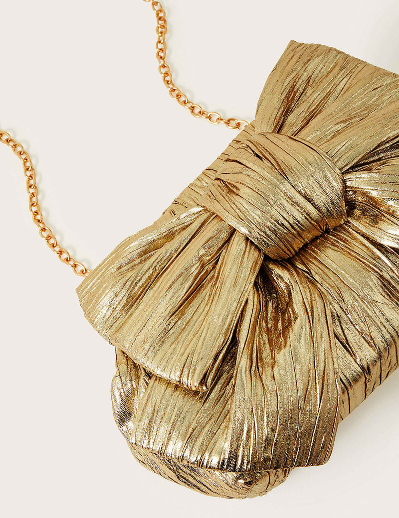 Monsoon metallic bow clutch bag, imported from the UK