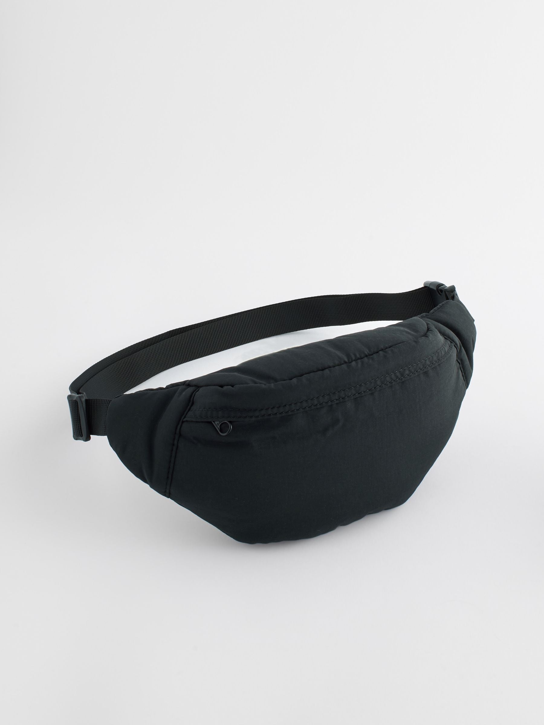 Black cross-body bag with nylon shell and polyester lining, UK version
