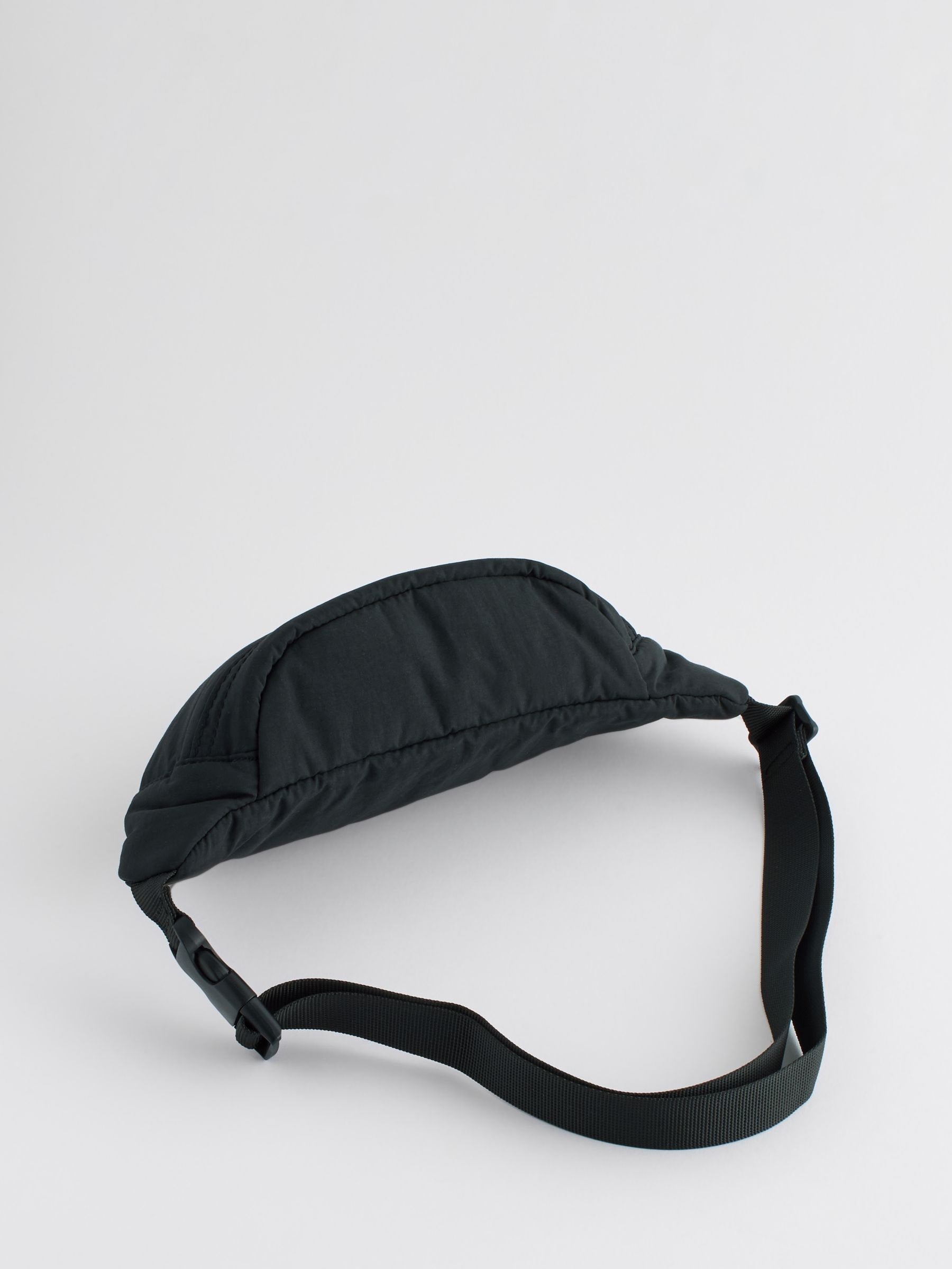 Black cross-body bag with nylon shell and polyester lining, UK version